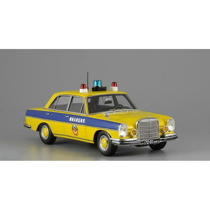 A 1975 Mercedes-Benz W108 'Moscow Police' model car in yellow, blue, and white colors with black wheels and interior.
