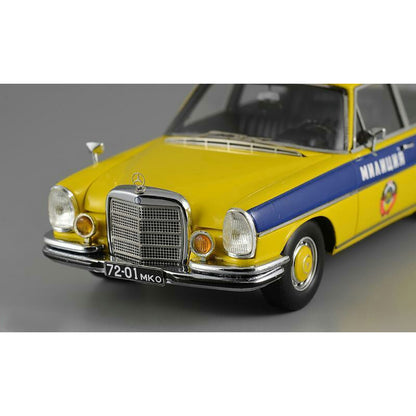 A 1975 Mercedes-Benz W108 'Moscow Police' model car in yellow, blue, and white colors with black wheels and interior.