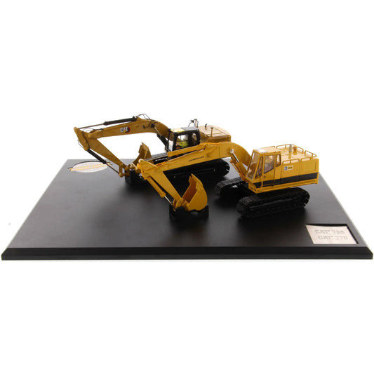 Model of a yellow excavator on a black platform with a white background