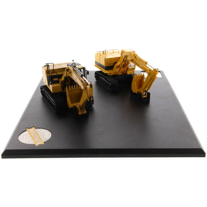 Two toy excavators on a black display stand with a white background