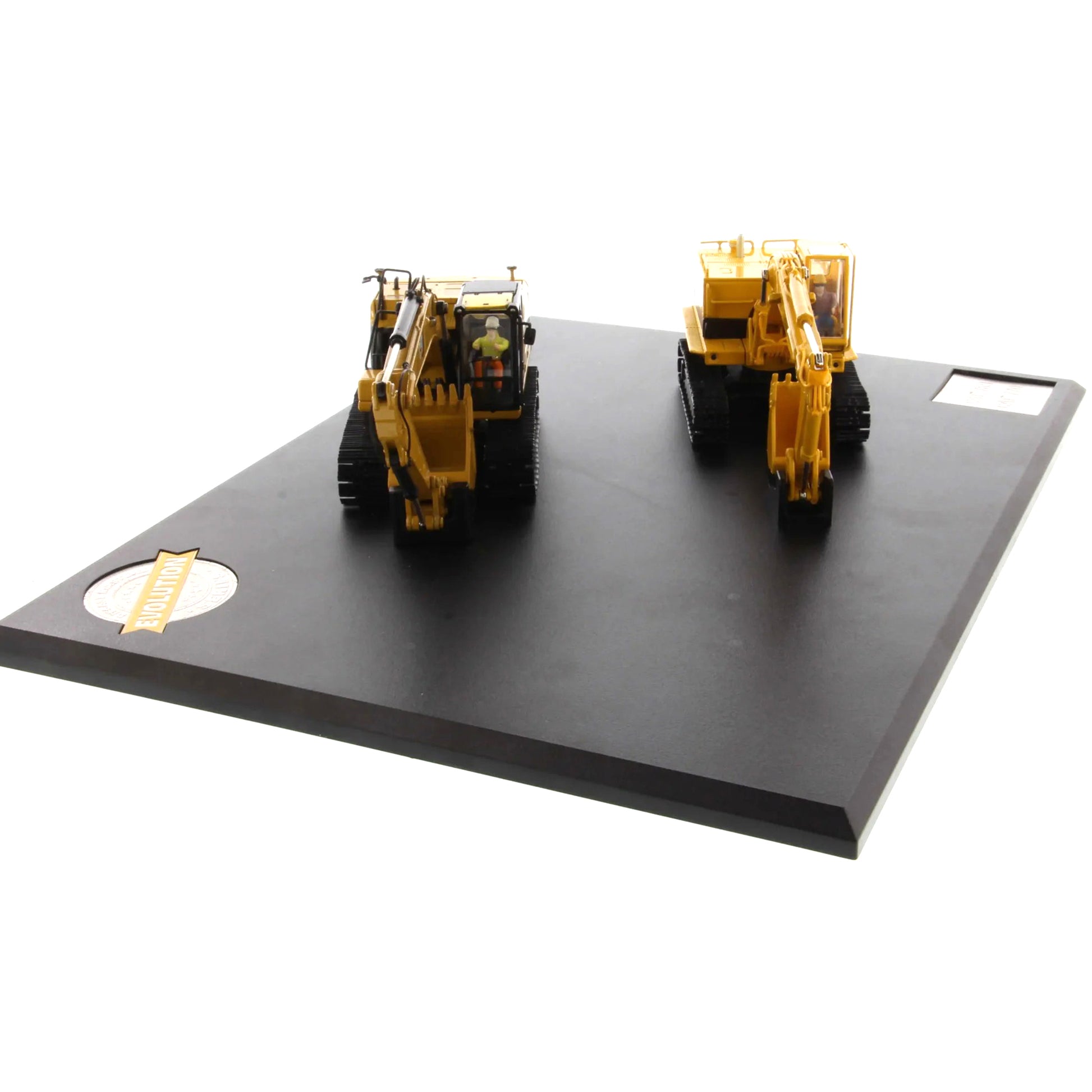 Two toy construction vehicles on a black platform with a white background