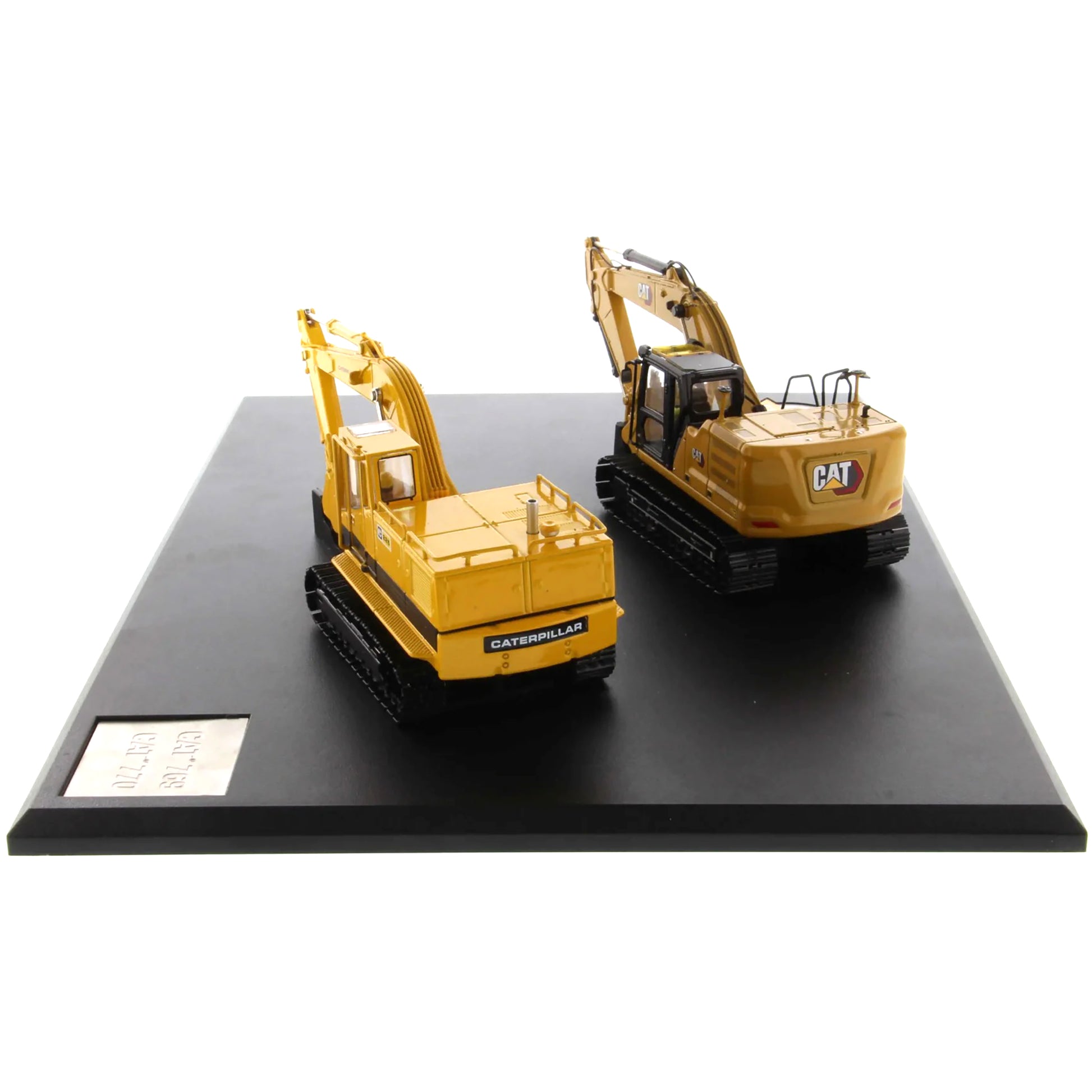 Two model excavators on a black platform with a white background