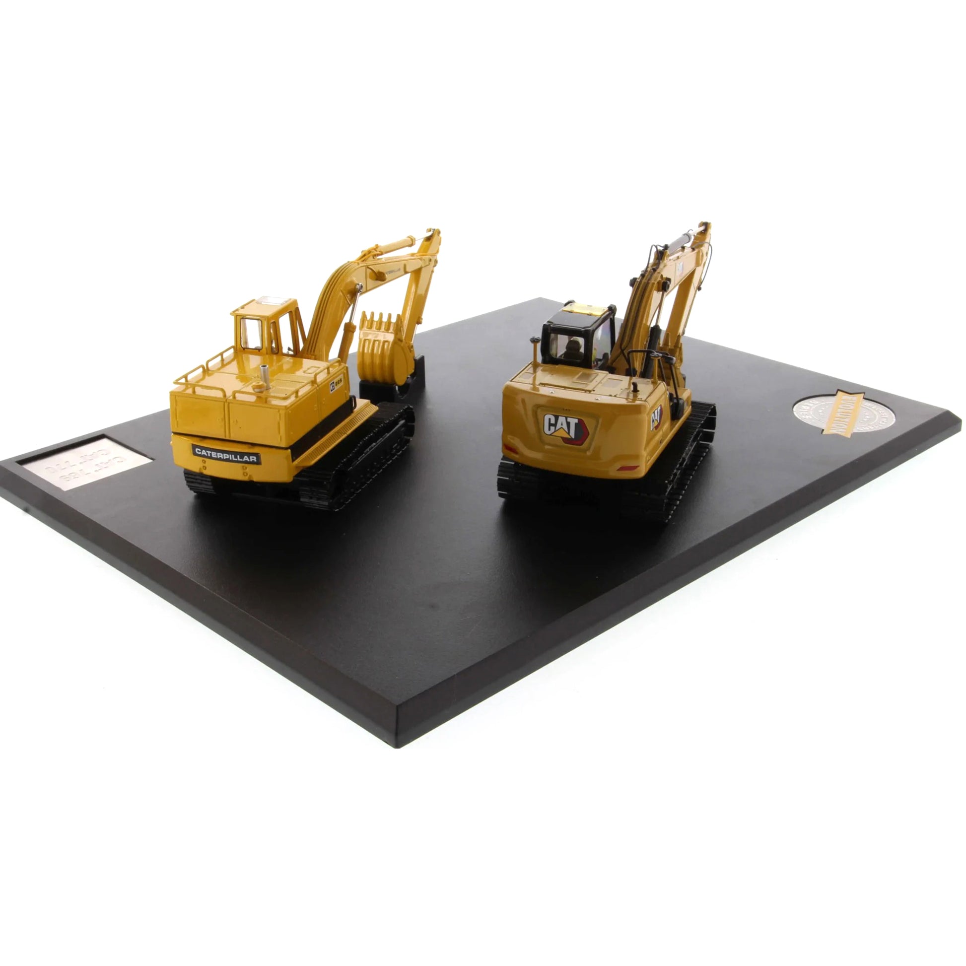 Two model excavators on a black platform with a white background