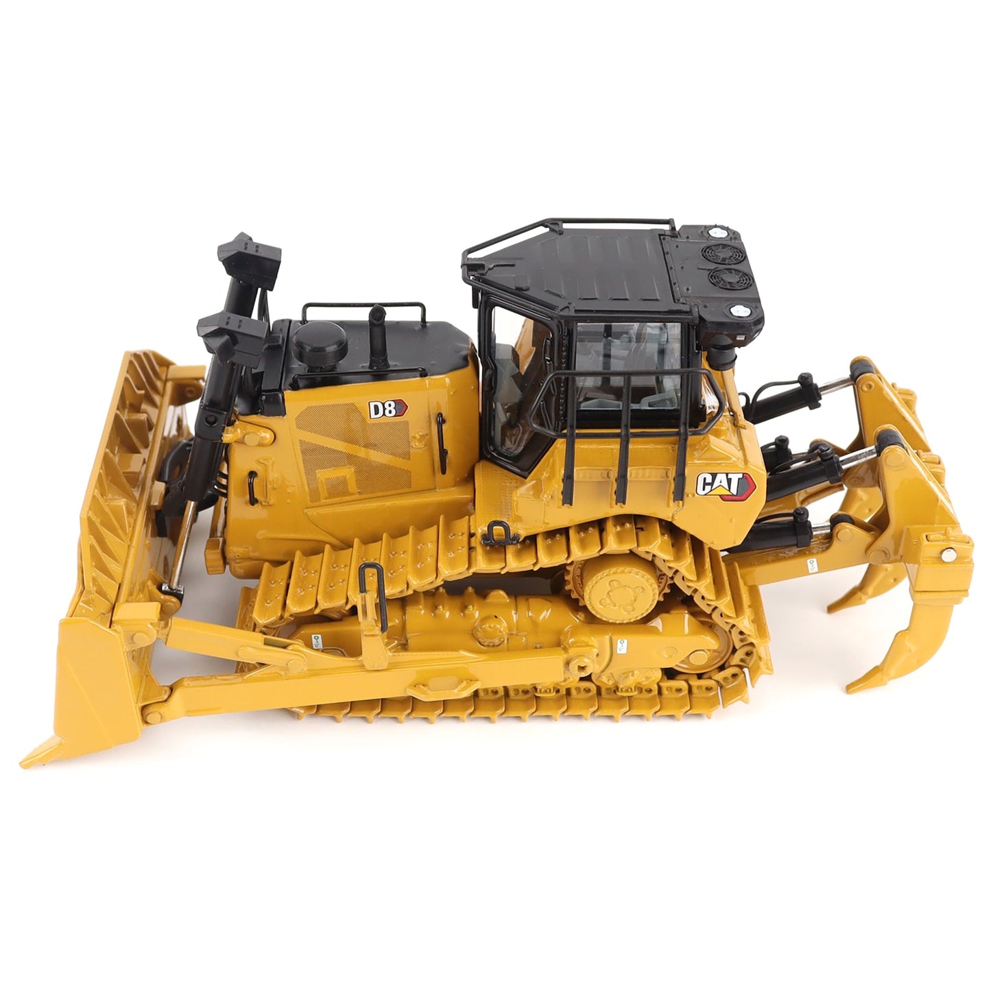 Yellow toy bulldozer with black details on a white background