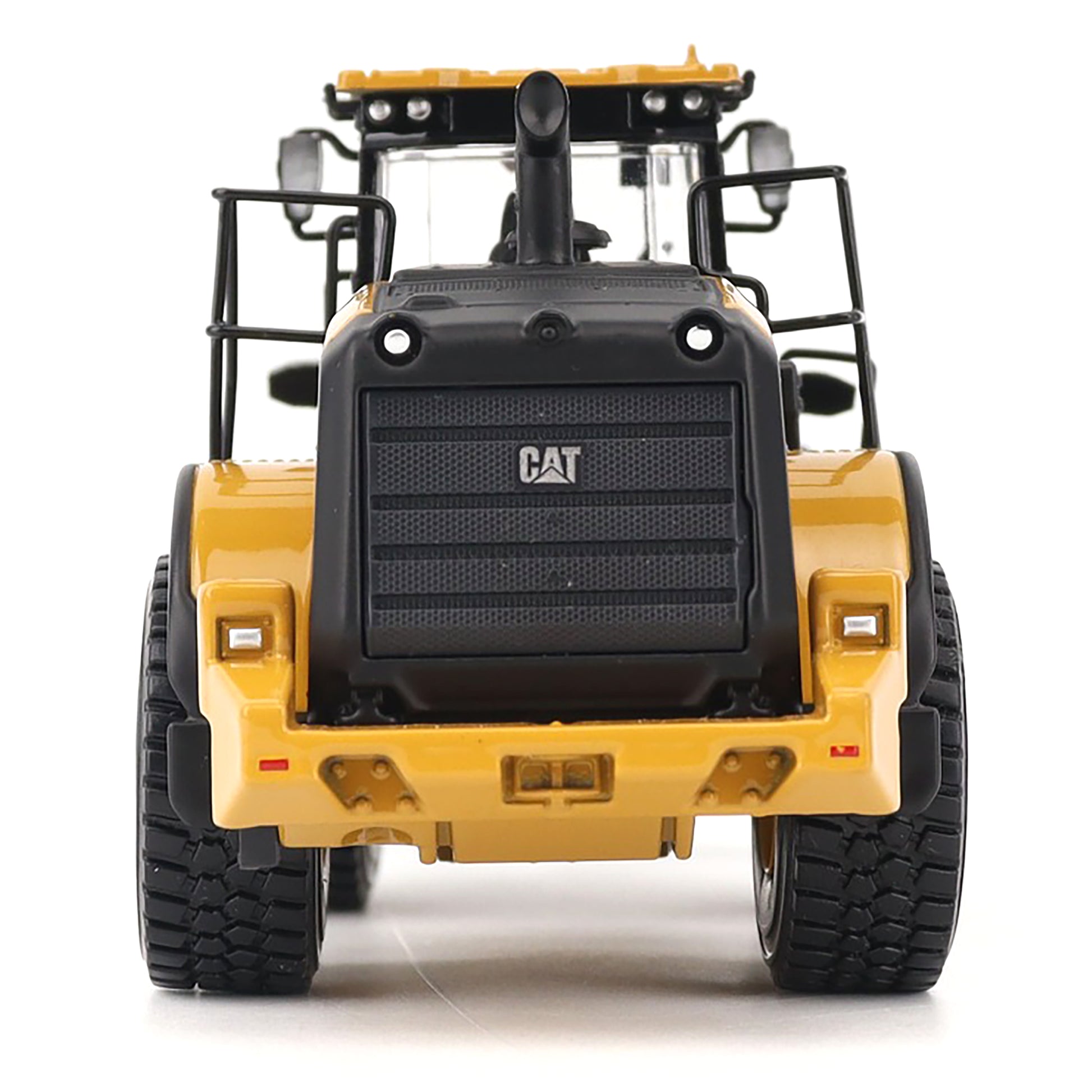 Back view of a yellow and black Caterpillar loader on a white background