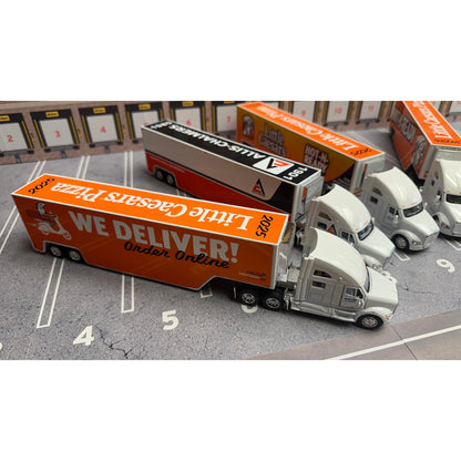 Model trucks with Little Caesars Pizza and Allis Chalmers branding on a parking lot background.