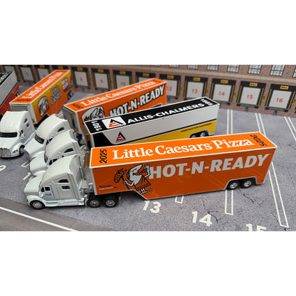 Model trucks with Little Caesars Pizza and Allis Chalmers branding on a parking lot background.