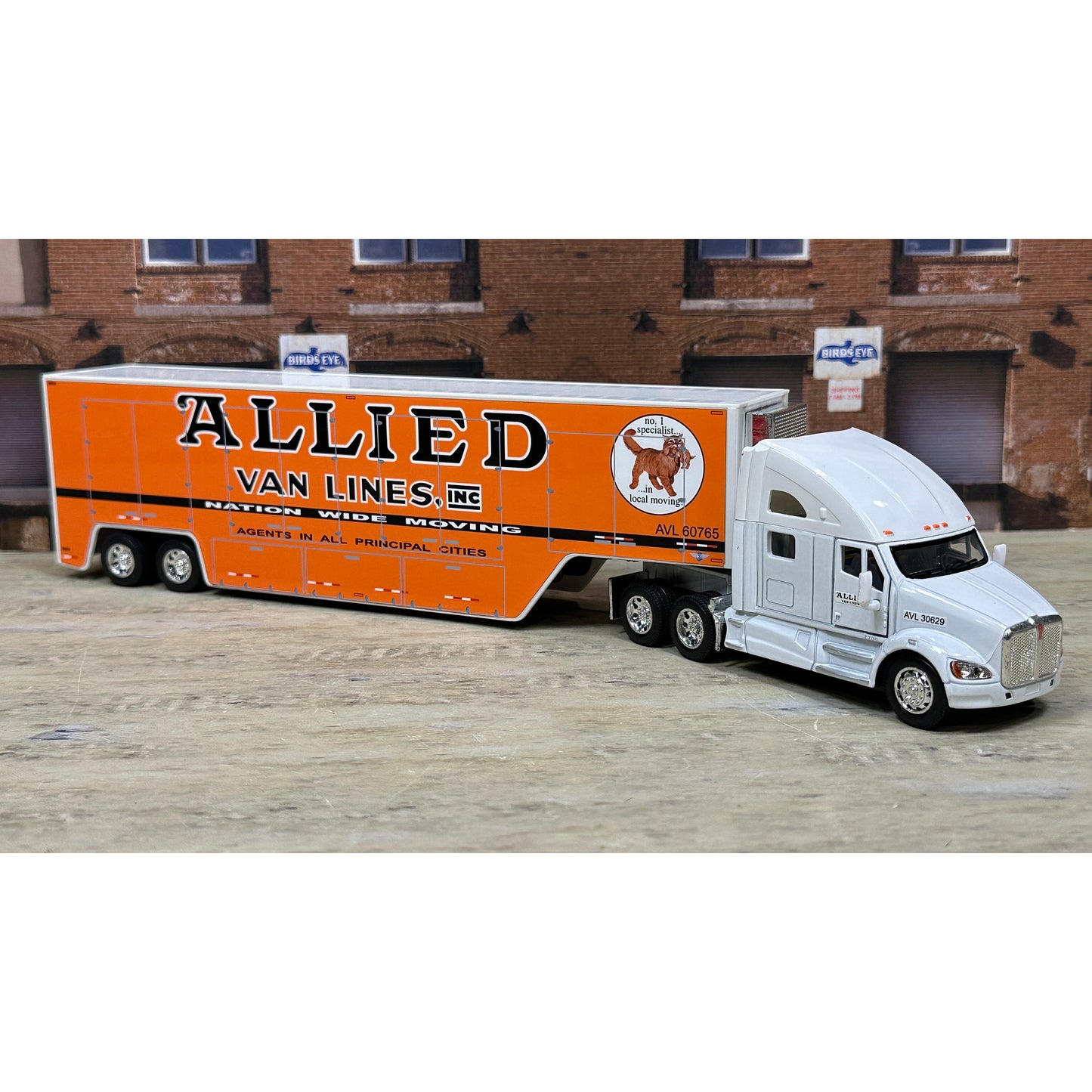Model truck with 'Allied Van Lines' branding on a wooden floor.