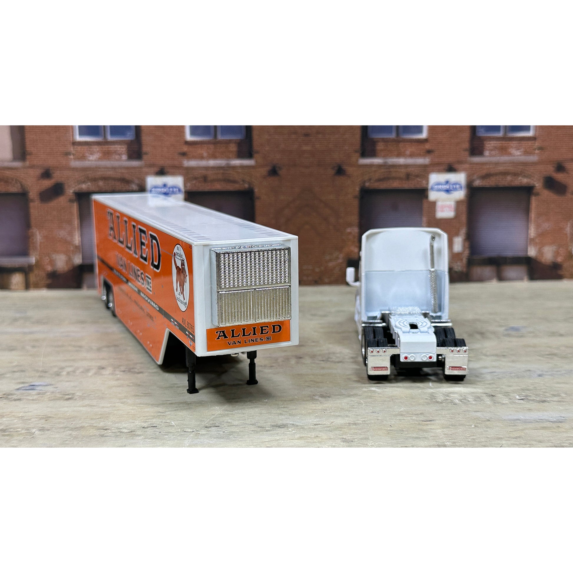 Model of a truck with 'Allied' branding in front of a brick building.