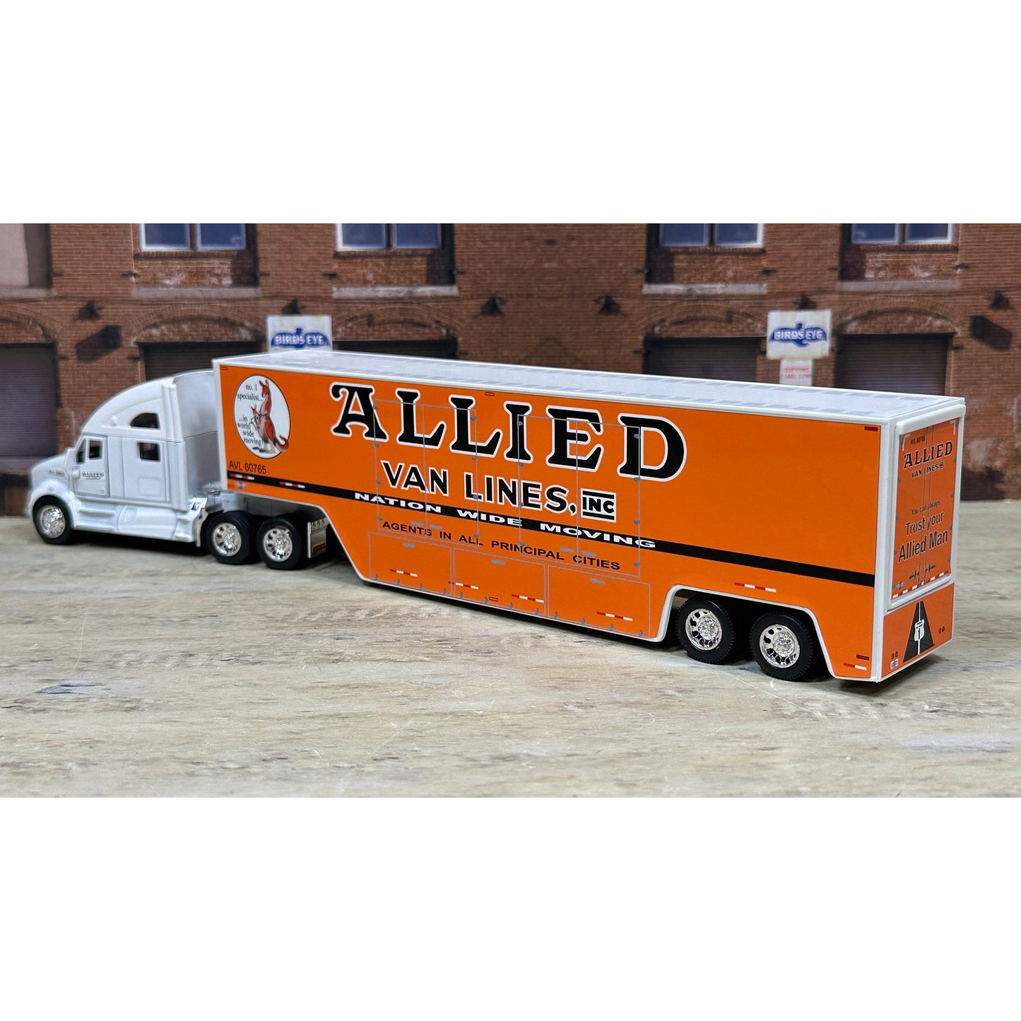 Model of a semi-truck with 'Allied Van Lines' branding on an urban background.