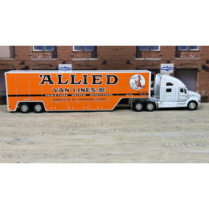 Model truck with 'Allied Van Lines' branding in front of a brick building.