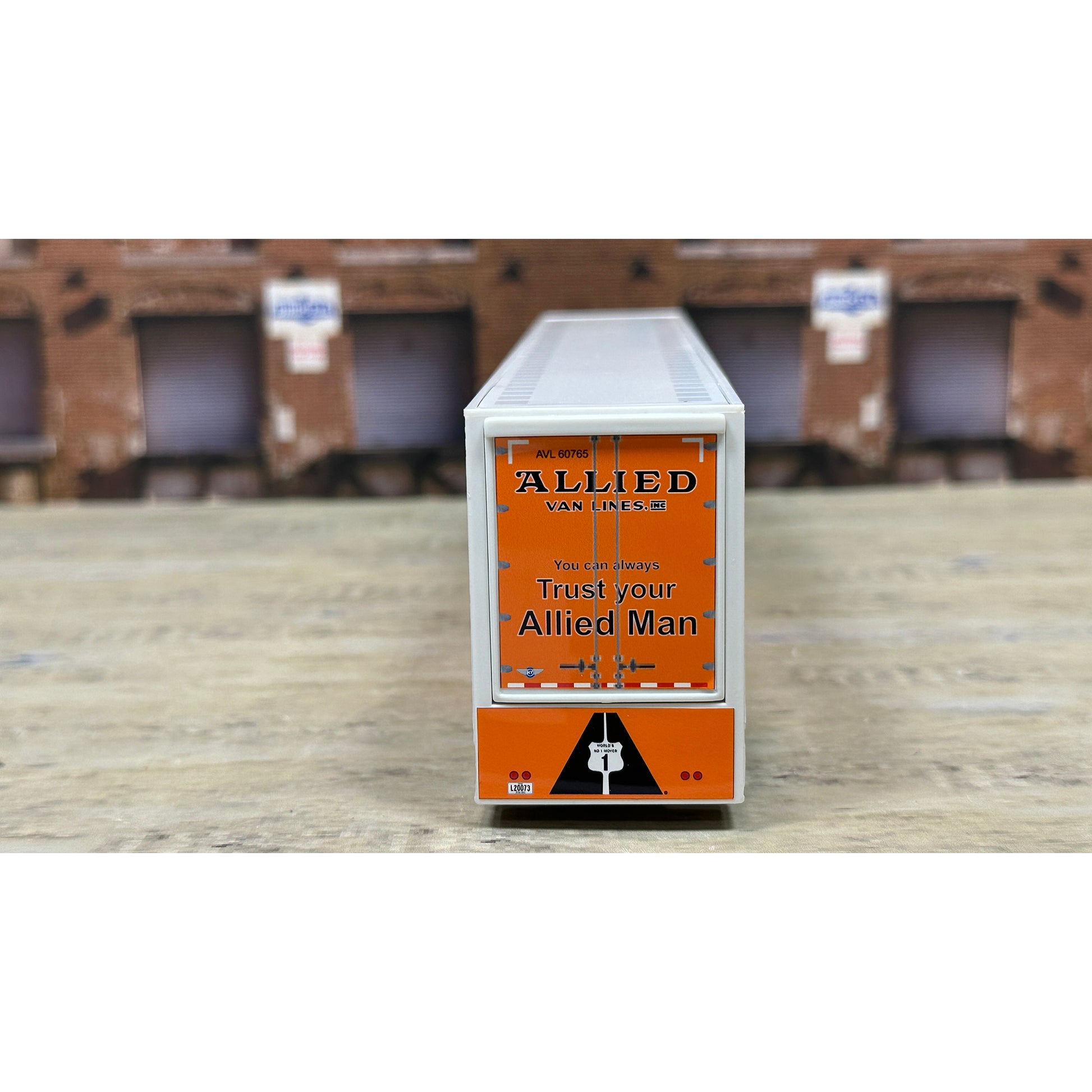 Rectangular box with Allied Van Lines branding on a wooden surface.