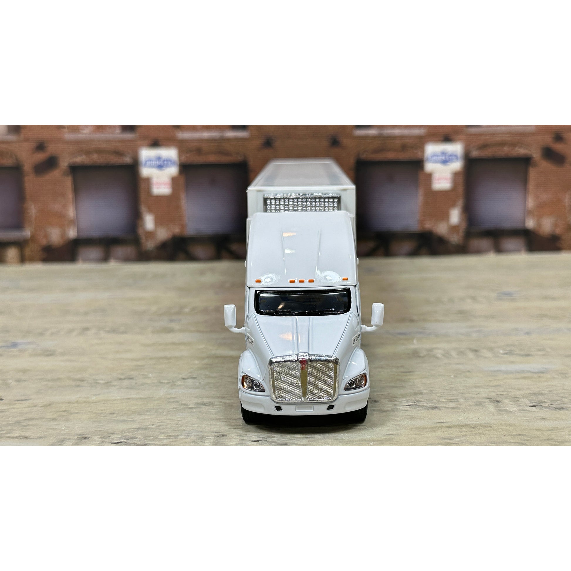 Model of a white truck on a wooden surface with a blurred background