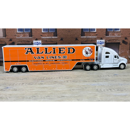 Model truck with 'Allied Van Lines' branding in front of a brick building.