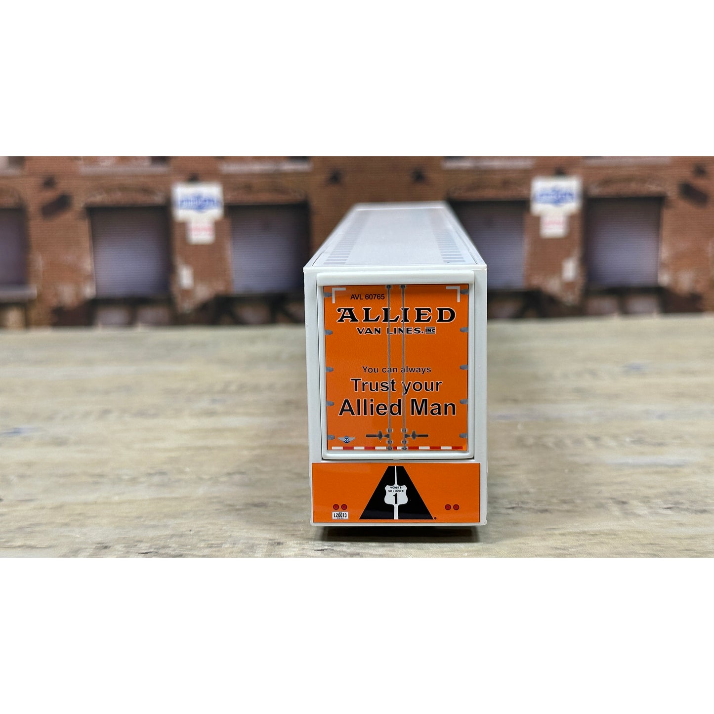 Rectangular box with Allied Van Lines branding on a wooden surface.