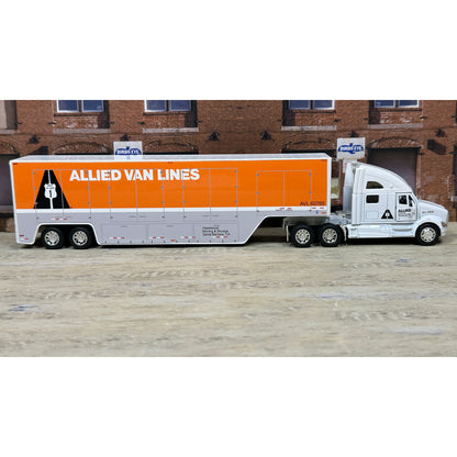 Model of a truck with 'Allied Van Lines' branding in front of a brick building.