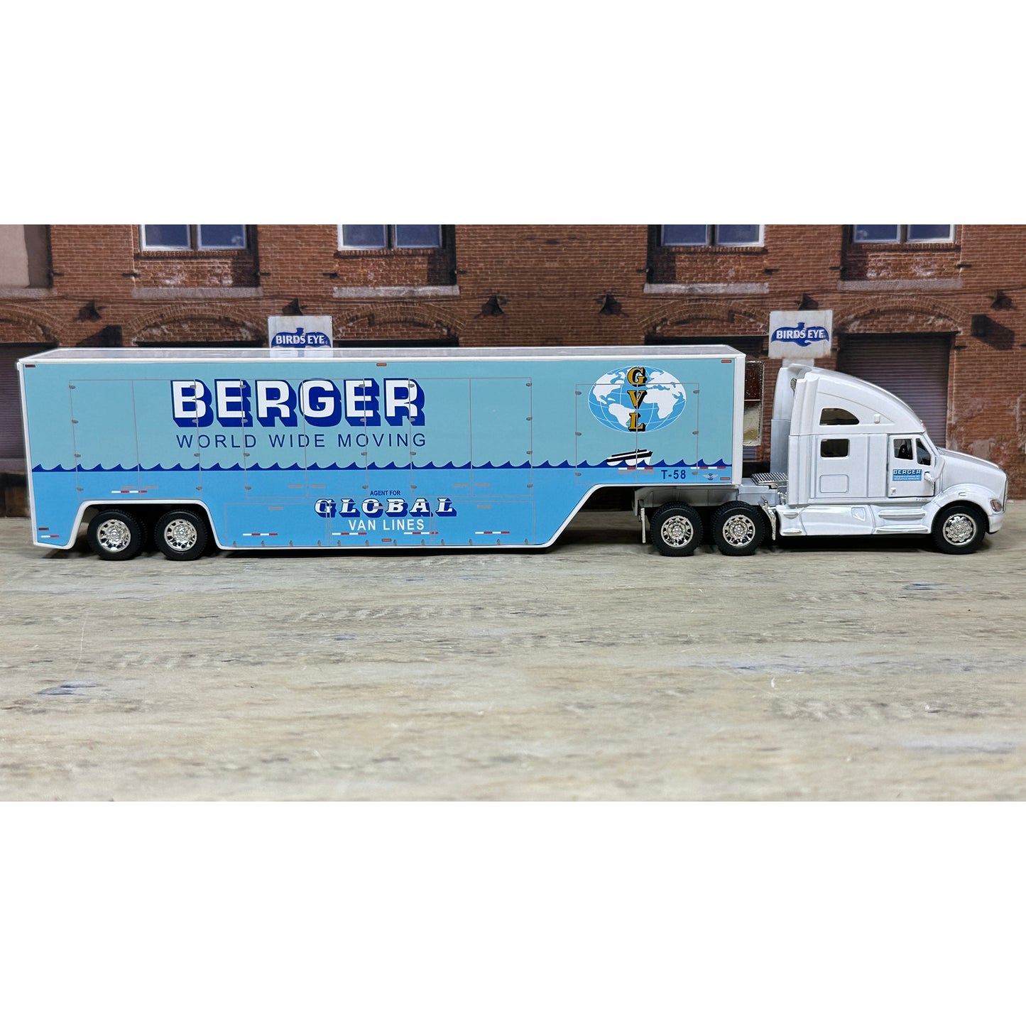 Model truck with 'Berger World Wide Moving' branding on a wooden surface.
