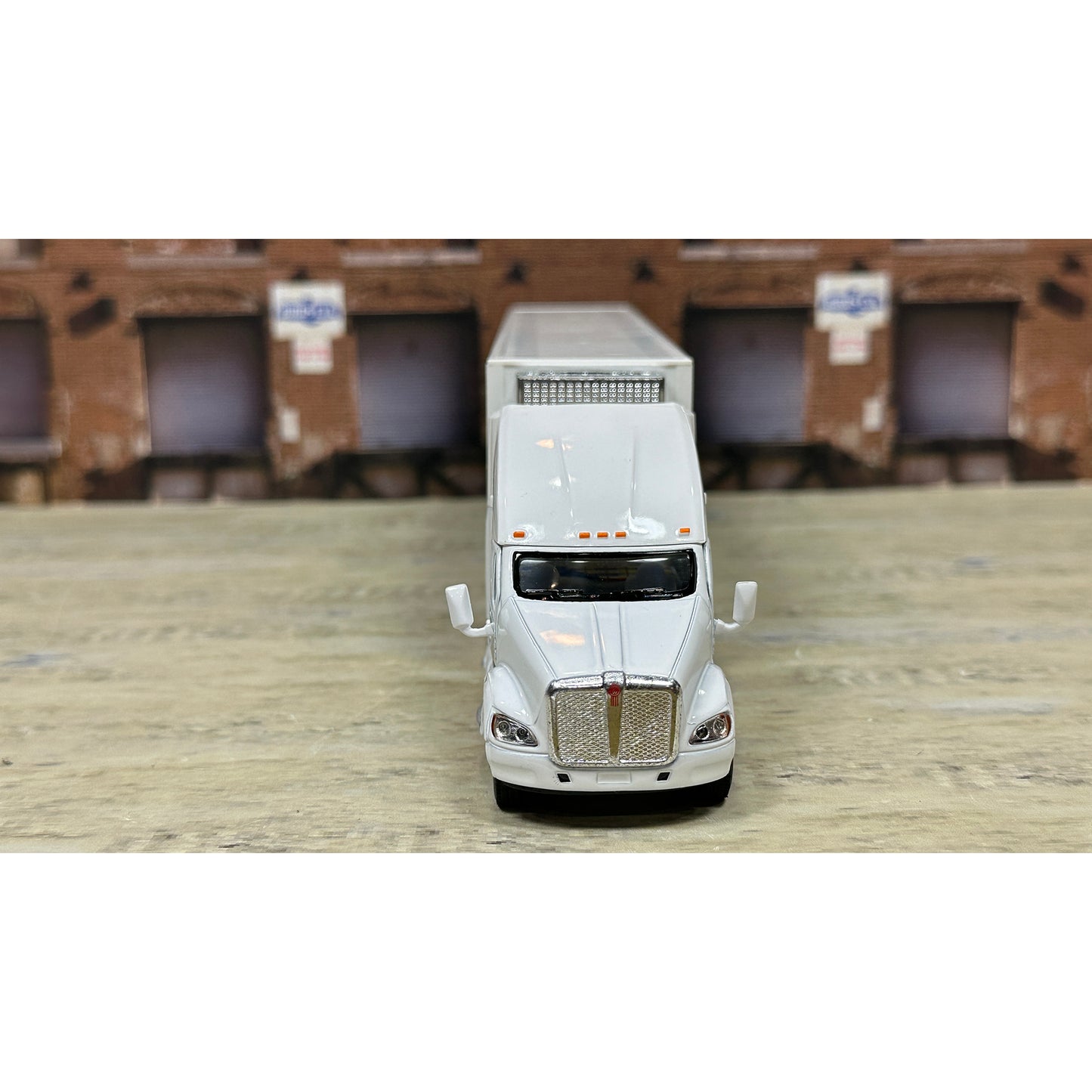Model of a white truck on a wooden surface with a brown textured background