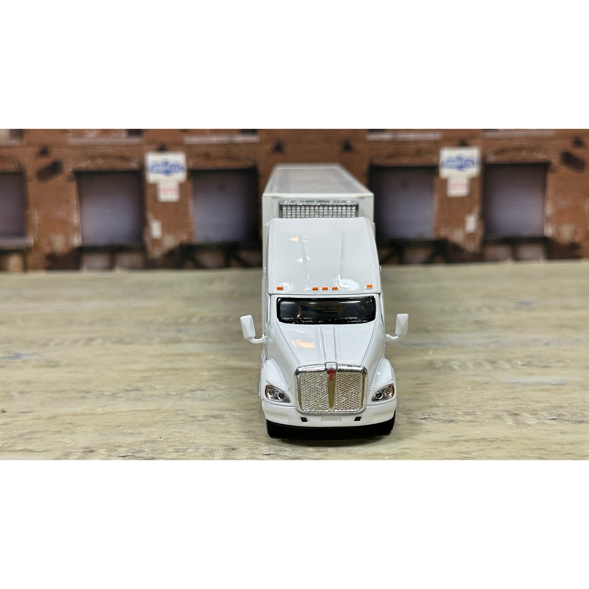 Model of a white truck on a wooden surface with a brown textured background