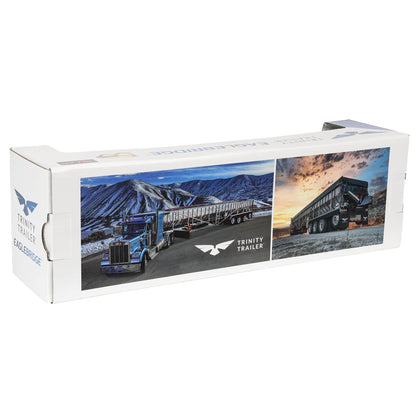 A long white cardboard box for a Trinity Trailer Eagle Bumper, featuring printed photos of semi-trailers and mountains on the front and side panels.